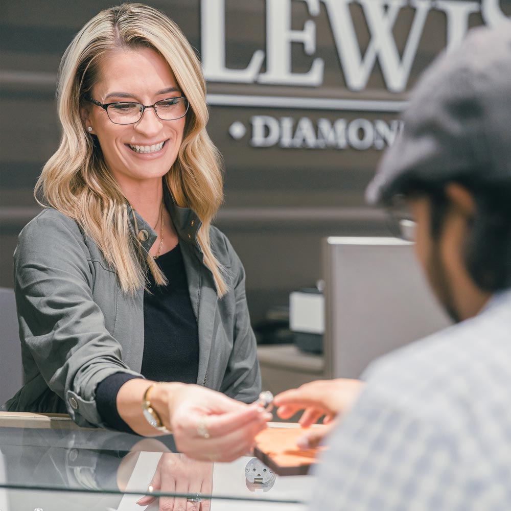 Lewis-Diamond-Co-employee-showing-a-ring-to-a-customer